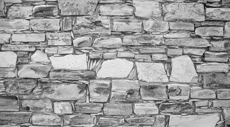 ancient masonry of cobblestones and stones for the sidewalk wall and road, street of the ancient cityの写真素材