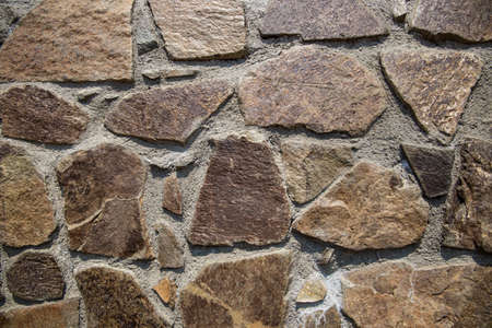 ancient masonry of cobblestones and stones for the sidewalk wall and road, street of the ancient cityの写真素材