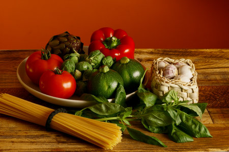 Mix of vegetables for Italian penne. Red Bell pepper, Garlic, Tomatos, Brussels sprout, Artichoke, Courgette, Basil and Spaghetti.の写真素材