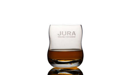 Jura Single Malt Scotch Whisky in a glass white backgroundの写真素材