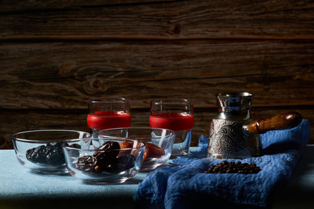 Coffee pot (Cezve), two glasses of coffee, coffee beans and dry fruits.の写真素材
