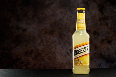 Tel-Aviv,Israel - 20.04.21.Bacardi breezer light alcohol beverage in pineapple taste on a table against the dark background.のeditorial素材