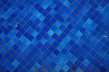 Background texture of blue tile underwater. Small tiles with some distortion effect because of water.の写真素材