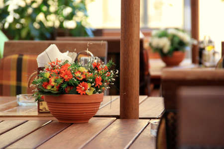 beautiful flowers in the pot on a table in the restaurant.の写真素材