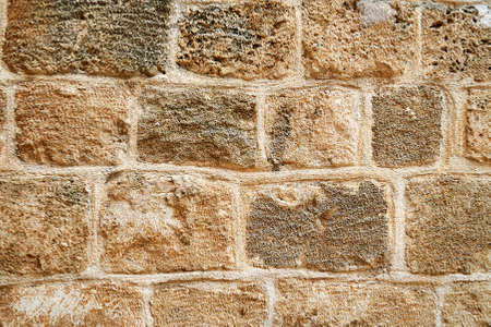 Background texture of bricks in yellow, brown and grey colors.の写真素材