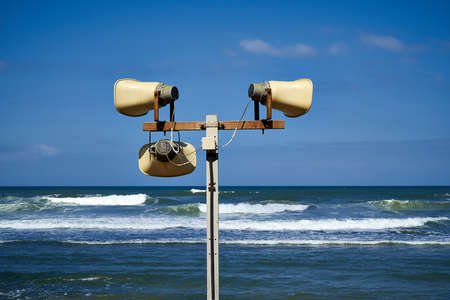 Three loudspeakers on a sea coast. Megaphone Attention.の写真素材
