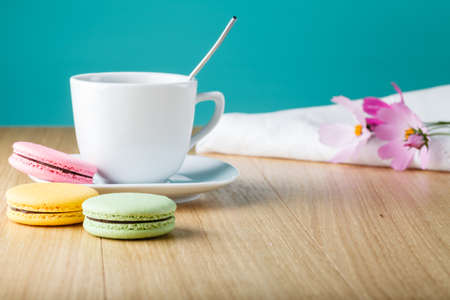 Coffee cup with colorful french macaronの写真素材