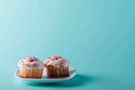Colorful muffin on saucer.  Aqua color backgroundの写真素材