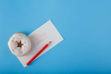 Donut with scrap of paper and painted heart