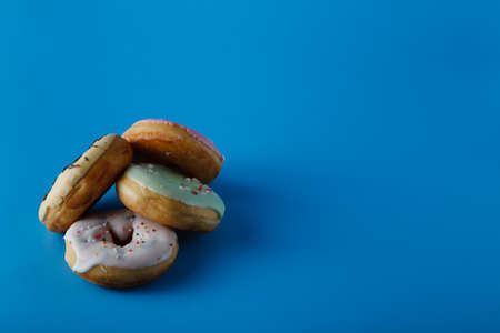Donuts on blue shadeless background with space for writingの写真素材