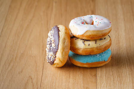 Donuts on wood table with colorful culinary decorationの写真素材