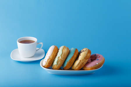 Donuts on dish and shadeless blue background