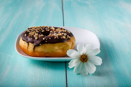 donuts on old wood table with flowerの写真素材