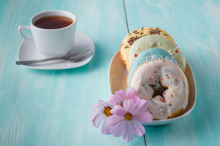 Four donuts on old wood tableの写真素材