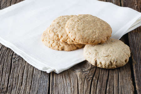 Oat cookies on rustic wooden table and cloth