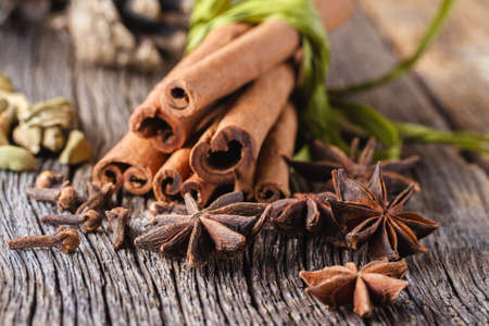 Christmas or new year decoration. Spices for mulled wine on weathered wooden table