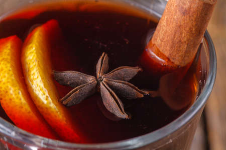 Mulled wine and spices closeup in glass cup. Homemade wine conceptの写真素材