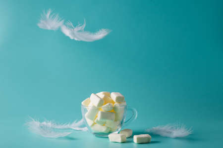 Pastel color marshmallow in glass, fly plumele. lightness conceptの写真素材