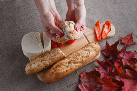 Sliced bread on wood with fall leaves in backgroundの写真素材