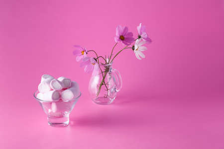 Pink marshmallows on pink background with flowersの写真素材
