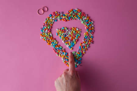 female finger painted colored heart from sweet drageesの写真素材