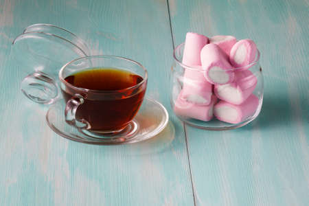 Tea cup and pink marshmallows in jarの写真素材