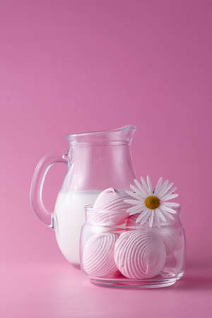 Pink marshmallow, cup milk and flowersの写真素材