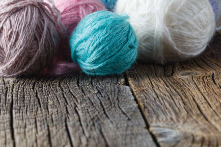 Clews of colored wool yarn on wooden tableの写真素材