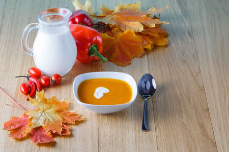 Pumpkin soup with fall leavesの写真素材
