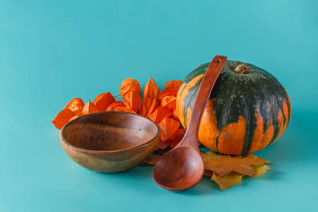 Colored pumpkin and fall harvest on aquamarine shadowless backgroundの写真素材