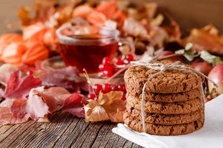 Fall wealth on rustic wooden background with oat cookiesの写真素材