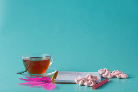 Sweet meringue with notes and teacupの写真素材