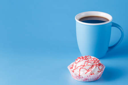 blue mug on blue background with meringue sweetの写真素材