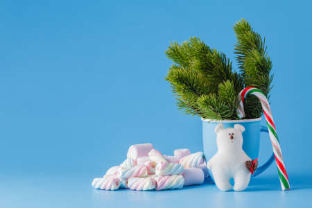 Xmas decoration concept. Pine and white bear toy on blue backgroundの写真素材