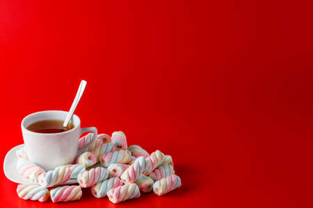 Heap of sweets on plain red background