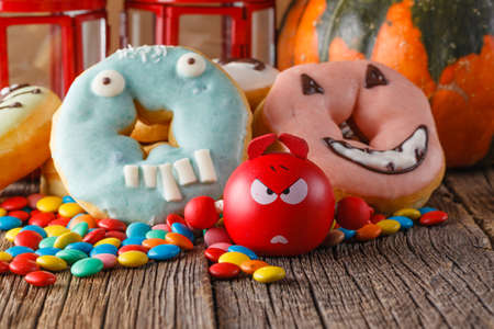Halloween donuts on rustic wooden tableの写真素材