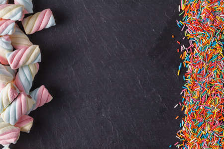 Fun sweet frame on slate black background for text placement. Top viewの写真素材