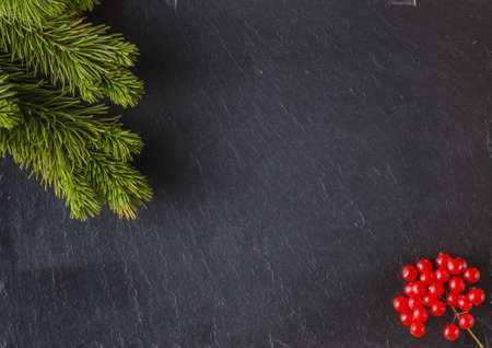 New year frame concept. Place to you text with inscription of christmas on slate black  background with pineの写真素材