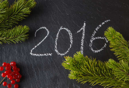 New year frame concept. Place to you text with inscription of christmas on slate black  background with pineの写真素材