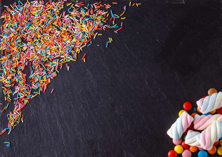 Fun sweet frame on slate black background for text placement. Top viewの写真素材