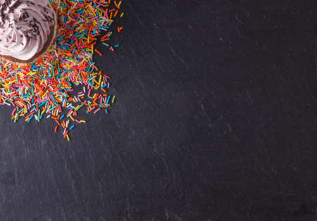 Fun sweet frame on slate black background for text placement. Top viewの写真素材