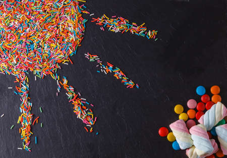 Fun sweet frame on slate black background for text placement. Top viewの写真素材