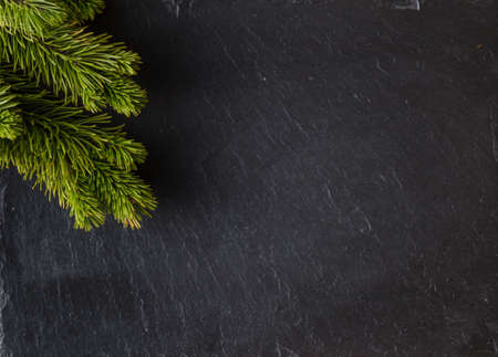 New year frame concept. Place to you text with inscription of christmas on slate black  background with pineの写真素材