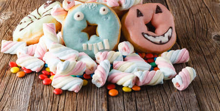 Halloween donuts on rustic wooden tableの写真素材
