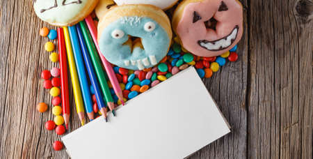 Halloween donuts on rustic wooden tableの写真素材
