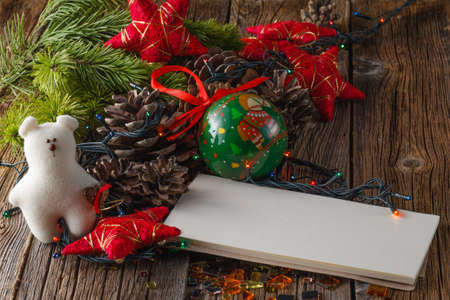 christmas decoration on rustic wooden table with empty note. Closeup viewの写真素材