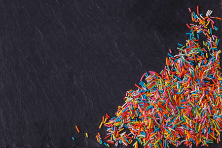 Fun sweet frame on slate black background for text placement. Top viewの写真素材