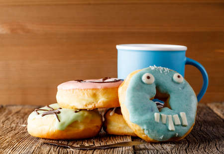 Halloween donuts on rustic wooden tableの写真素材