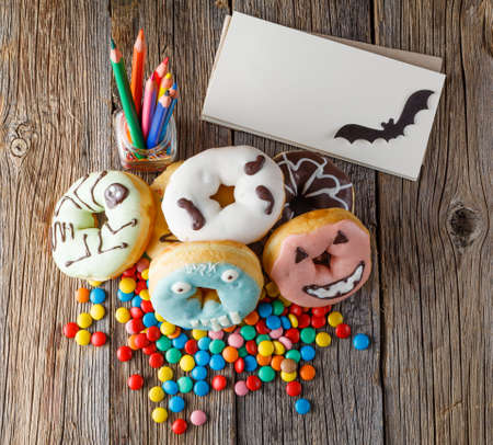Halloween donuts on rustic wooden tableの写真素材