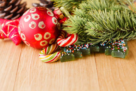 New year decoration on wood table with pine, sweets and red starsの写真素材